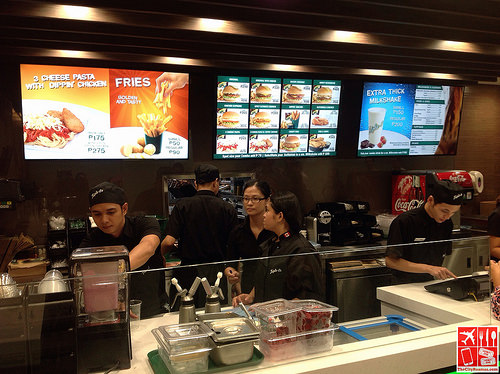 The crews at the counter of Triple-O's by White Spot