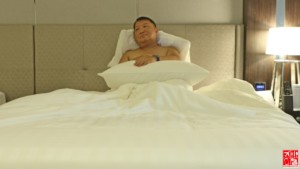 enjoying the comfy bed in my Le Charme Suites room