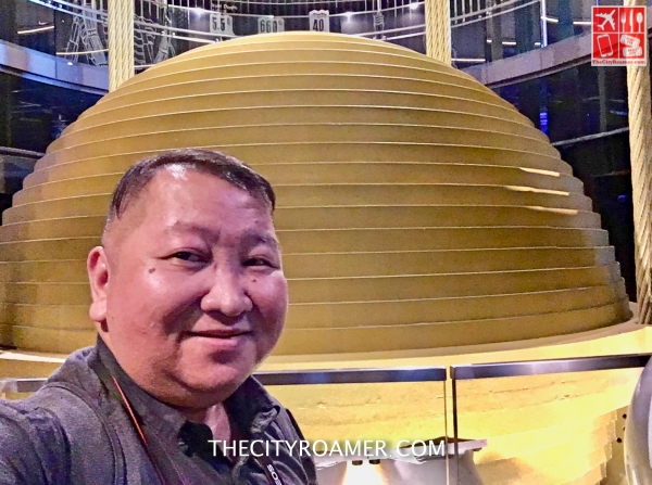 A selfie with the wind damper in the background_Fotor