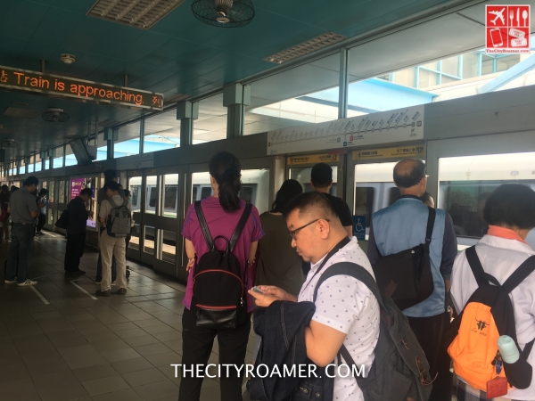 Checking info twice on my phone while waiting for our MRT Ride