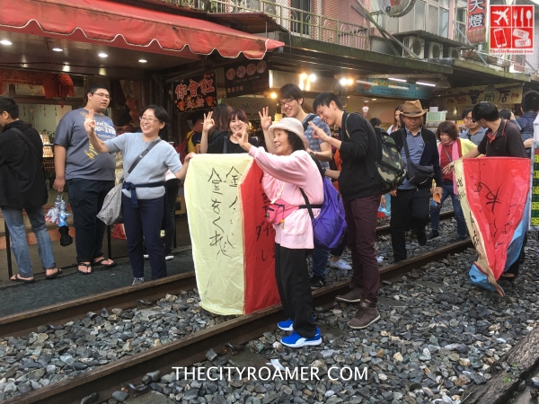 Tourists enjoying the Sky Lantern experience at Pingxi Old Street