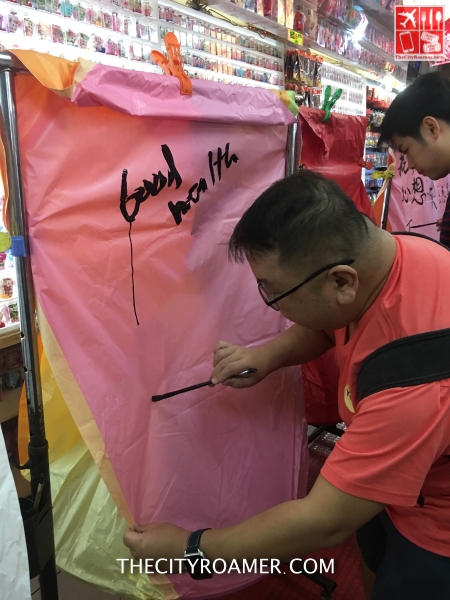 Writing down my wish on one side of the Sky Paper Lantern